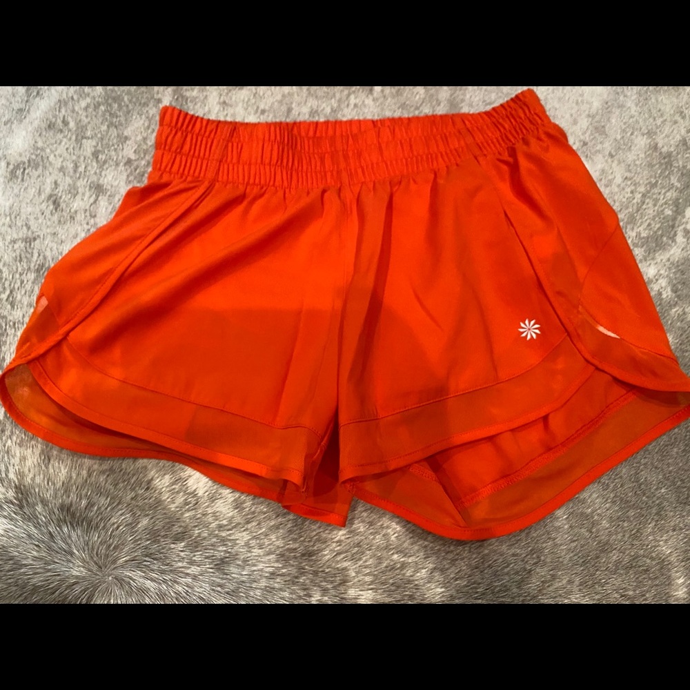 Orange athletic shorts from Athleta, size xxs